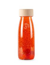Botella sensorial naranja flotante PB47636 Petit Boum 1